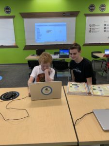 kids in the code ninjas classroom, working on a project