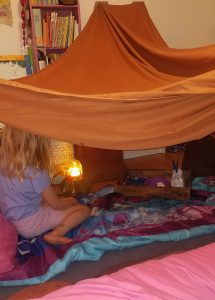 indoor sheet tent with sleeping bags and indoor s'mores kit
