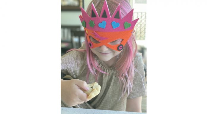 student eating hamantaschen