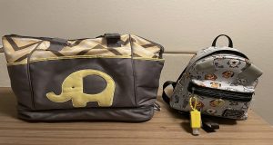 Yellow and gray diaper bag sitting next to a small gray backpack