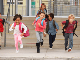 Kids running back to school with backpacks on