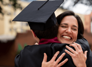 mom hugging son in cap and gown