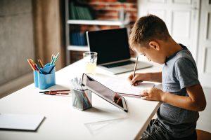boy doing work on tablet