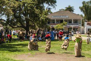Visitors hop, leap, and dash toward the finish line during spirited 19th-century games at the 2019 Fourth of July event in Old Town San Diego SHP. Photo from California State Parks